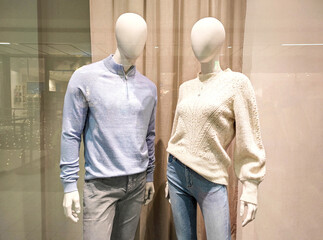 Wall Mural - Two mannequins in shop window. Female and male dummies. Family shopping