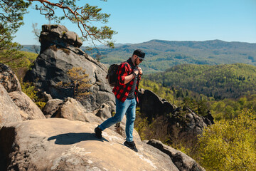 man hiker with backpack at dovbush rocks