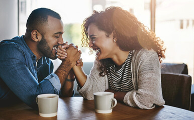 I put you first. Shot of a young couple spending time together at a cafe.