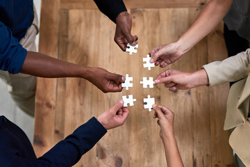 Aufkleber - Theyre not puzzled by success. High angle shot of a group of unidentifiable businesspeople building a puzzle together in the office.