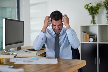 Aufkleber - When will I see an end to these deadlines. Shot of a young businessman looking stressed out while working in an office.