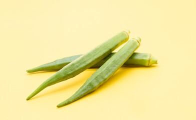 Lady Finger or okra isolated on yellow background,fresh cooking ingredient.