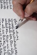 an orthodox jew hand writing a torah script