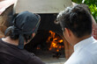 chef looking for the temperature in a wood-fired oven