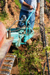 © francescomou - Farmer drives the plow while plowing the vineyard with the crawler tractor. Agricultural industry, winery.