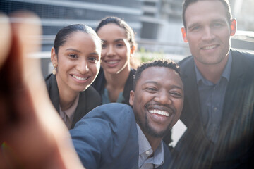 Canvas Print - Sometimes you just need to take a selfie. Shot of a group of businesspeople taking a selfie against a city background.