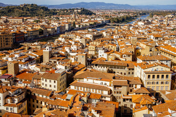 Wall Mural - Aerial cityscape of Florence city on a sunny day. Visiting italian cities in Tuscany. View from Vecchio palace