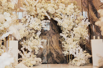 Wall Mural - Wedding arch decorated with white flowers at the wedding ceremony in the luxury restaurant.