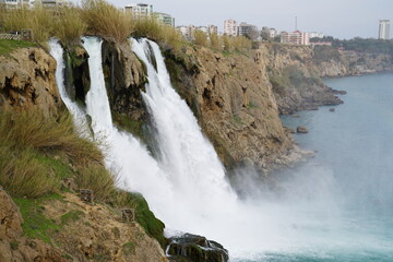 Wall Mural - Waterfall Duden (Düden) falling into the Mediterranean sea over high rocks. Waterfall falling into sea. Waterfall stream. ANTALYA