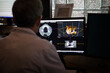 A radiologist observes a CT scan of the jaw prescribed for implant.