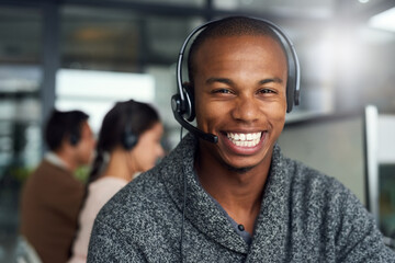 Poster - We take a keen interest in finding solutions for you. Portrait of a call centre agent working in an office with his colleagues in the background.