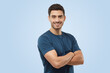 © Damir Khabirov - Athletic young sporty man in blue t-shirt standing with crossed arms
