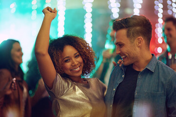 Poster - Gotta get my body moving. Shot of a young couple having fun on the dance floor.