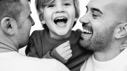 Wall Mural - Gay male couple of fathers and son having fun outdoor - LGBT diversity and family love concept - Black and white editing