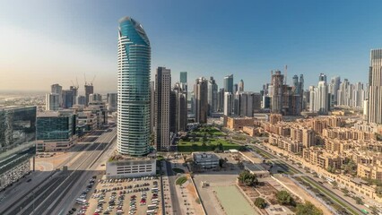 Wall Mural - Panorama showing Dubai's business bay towers aerial morning timelapse. Rooftop view of some skyscrapers