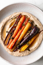 Honey Roasted Carrots With Hummus In A Ceramic Bowl.