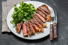 Grilled Steak Sliced On A White Plate