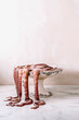 © The Picture Pantry - An octopus in an old and decorated footed dish, the tentacles falling outside on a marble table.