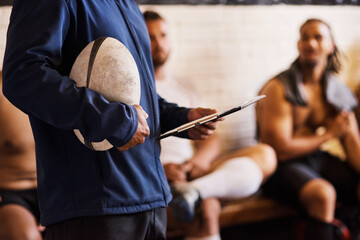 Sticker - Nobody knows whats best for the team like the coach. Cropped shot of a rugby coach addressing his team players in a locker room.