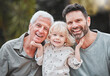 © Kirsten Davis/peopleimages.com - This is Dad and Grandad. Shot of a little boy posing outside with his father and grandfather.