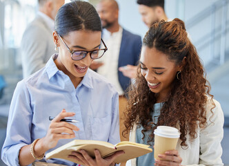 Canvas Print - Excited by all their amazing ideas. Shot of two businesswomen going through notes in an office with their colleagues in the background.