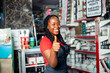 © wazkkii - Positive dark skinned female sale girl posing proudly in cosmetic supermarket given a thumbs up