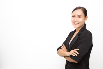 Beautiful Asian business woman wearing black suit with her crossed arms on white background and copy space.  Confident Asian working woman smiling and cheerful