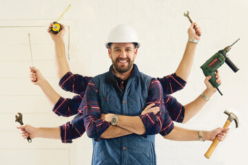 Fototapete - Hes got all the tools youll need. Portrait of a handsome young handyman tools in multiple hands.
