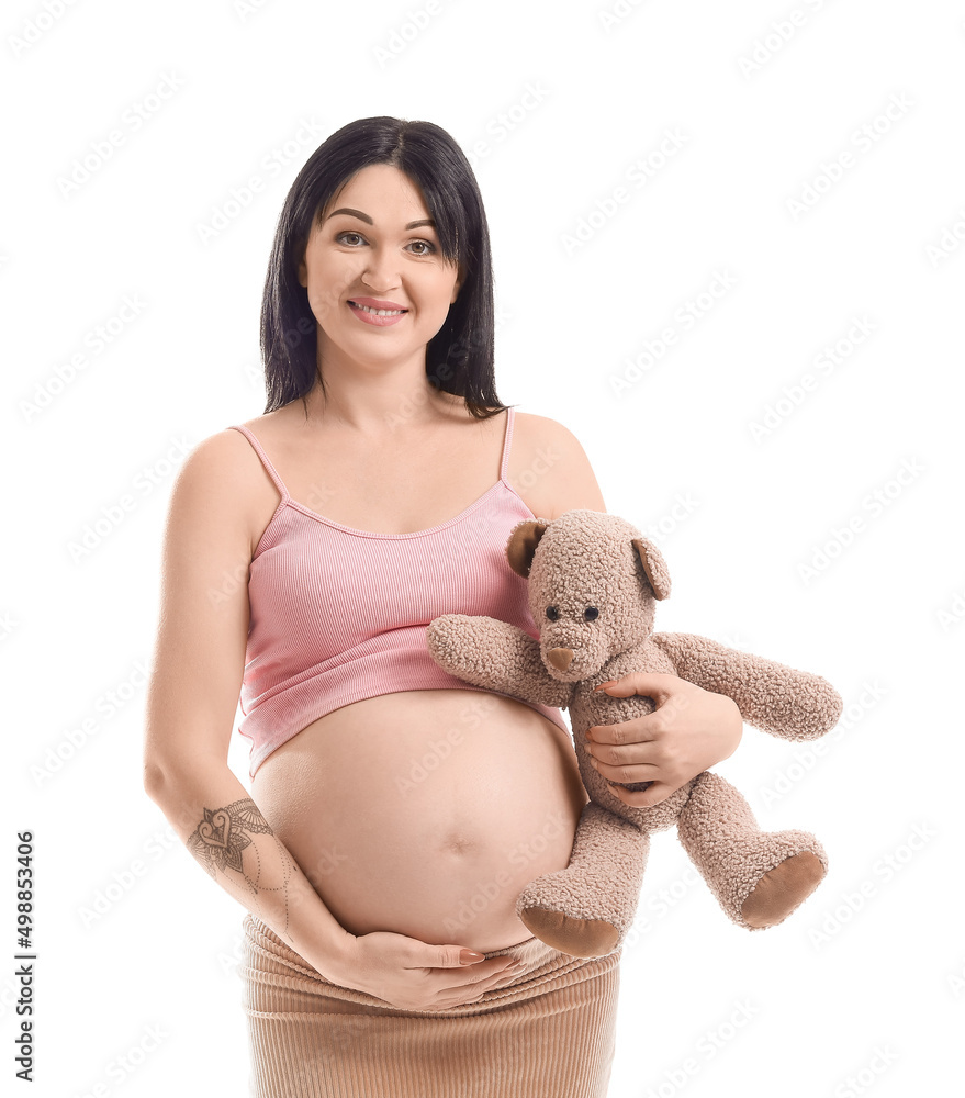 Pregnant young woman with teddy bear isolated on white
