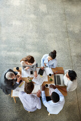 Poster - Boardroom brainstorming. High angle shot of a group of coworkers sitting around in a circle.