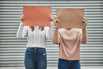 Wall Mural - Raise your voice. Cropped shot of two unrecognizable women holding signs while taking part in a political rally.