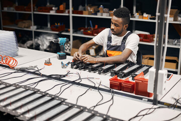 Wall Mural - Factory worker connecting wires at circuit