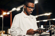 © sata_production - African engineer working with tablet at factory