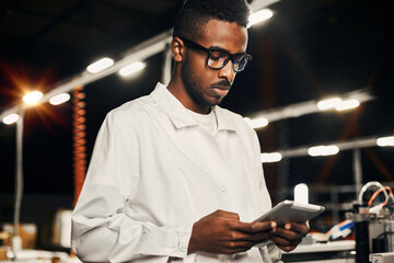 Wall Mural - african engineer working with tablet at factory