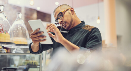 Aufkleber - I have space for your business meeting at two. Shot of a man talking on his cellphone in a coffee shop while using a digital tablet.