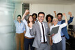 © NDABCREATIVITY - Happy group of business team celebrating a good job in the office. Business and finance concept.