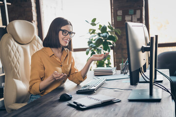 Portrait of happy positive lady sit chair communicate video call discuss explain colleagues workplace indoors