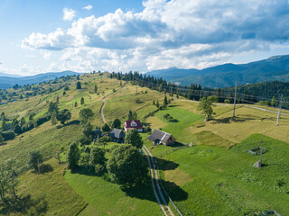 Wall Mural - Green mountains of Ukrainian Carpathians in summer. Sunny day, rare clouds. Aerial drone view.