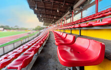 Empty Red Seat On Grandstand For Fans Cheering At Football Stadium