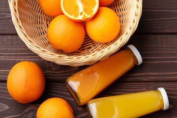 Wall Mural - Glass of fresh orange juice with fresh fruits on wooden table