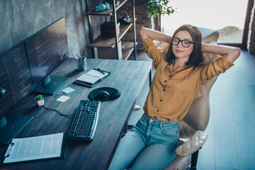 Poster - Portrait of attractive dreamy calm girl geek technician sitting resting in chair nap at workplace workstation indoors