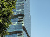 Fototapeta  - Modern high-rise glass and concrete office building in the city..Copy space