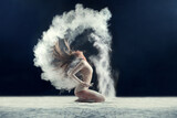 Sensationally sensual. Studio shot of a young woman leaving a trail of powder in the air by whipping her hair.