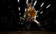 © master1305 - In action. Young basketball player jumping with ball in flashlights over dark gym background. Concept of sport, energy and dynamic, healthy lifestyle. Arena's drawned