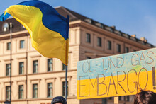 Embargo Oil Gas Banner And Ukrainian Flag On Demonstration In Support Ukraine In German. Ban The Transportation Of Gas And Oil Concept.