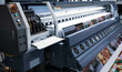 Industrial technician operating corrugated cardboard digital inkjet printer. Printing industry.