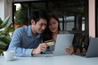 © Natee Meepian - Asian couple at home shopping online with digital tablet and credit card
