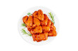 Marinated chicken wings in red sauce on isolated white background.Top view.Copy space.Semifinished. Fast cooking.Raw marinated chicken meat.