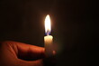 © Alif_Mahamud - Holding burning candle in the darkness