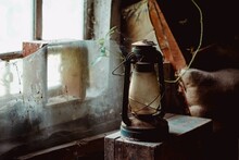 An Old Kerosene Lamp On The Window